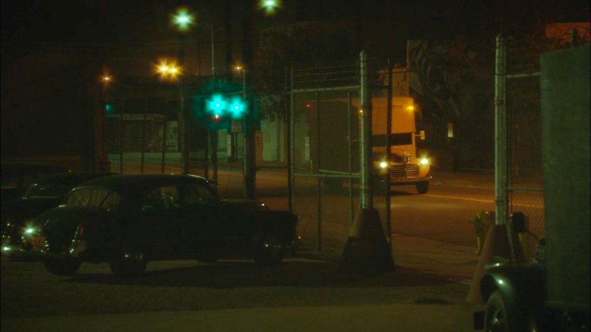 A truck approaching the Manfredi Shipping Warehouse at night.