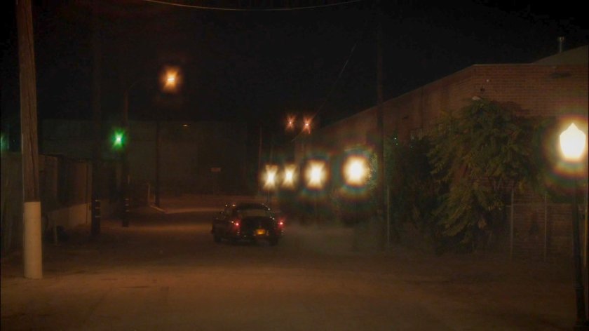 Manfredi's car driving away at night.