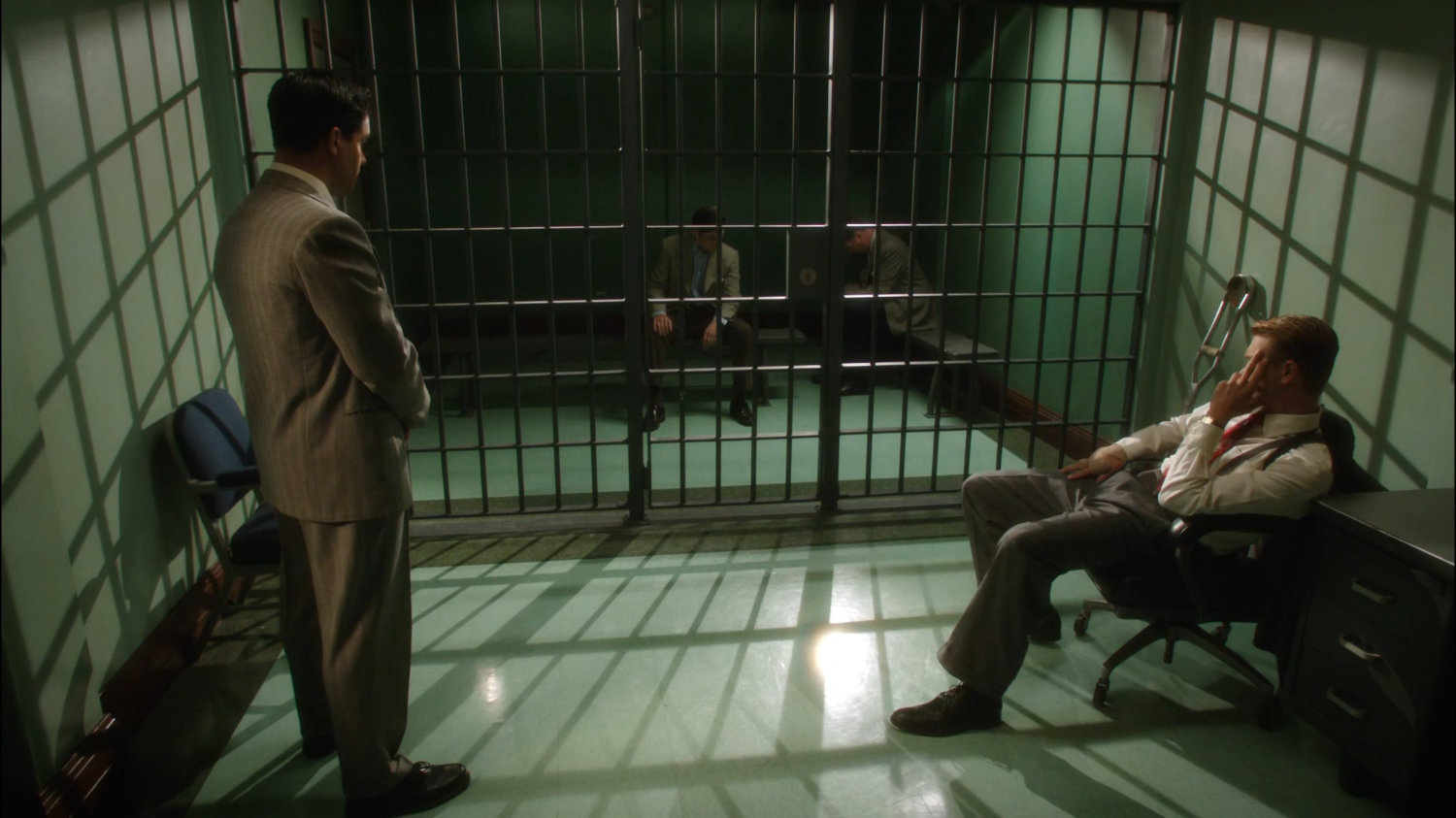 Thompson and SSR Agent looking at Sousa and Samberly in SSR cell.