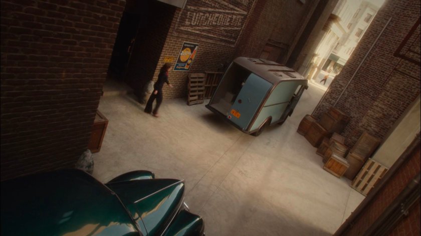 Peggy walking towards van in Alley outside Auerbach Theatrical Agency.