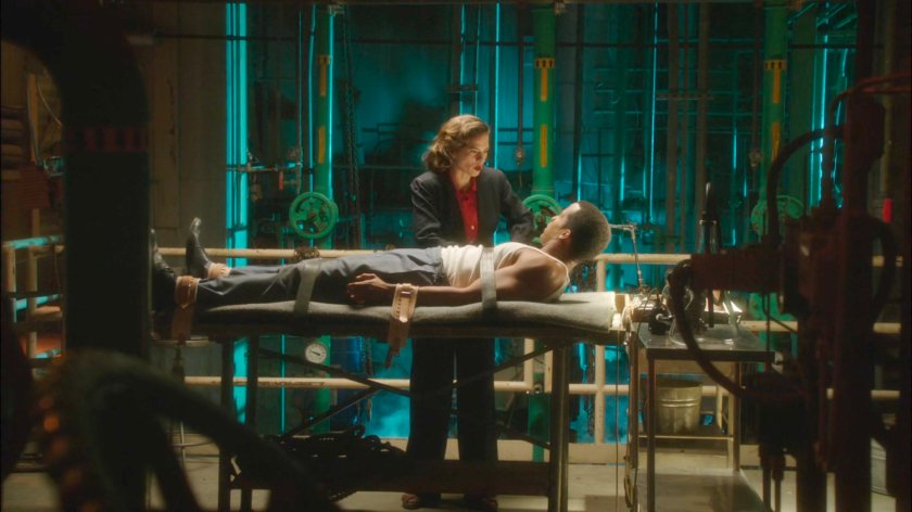 Peggy unstrapping Jason from gurney in Manfredi Waste Management facility.