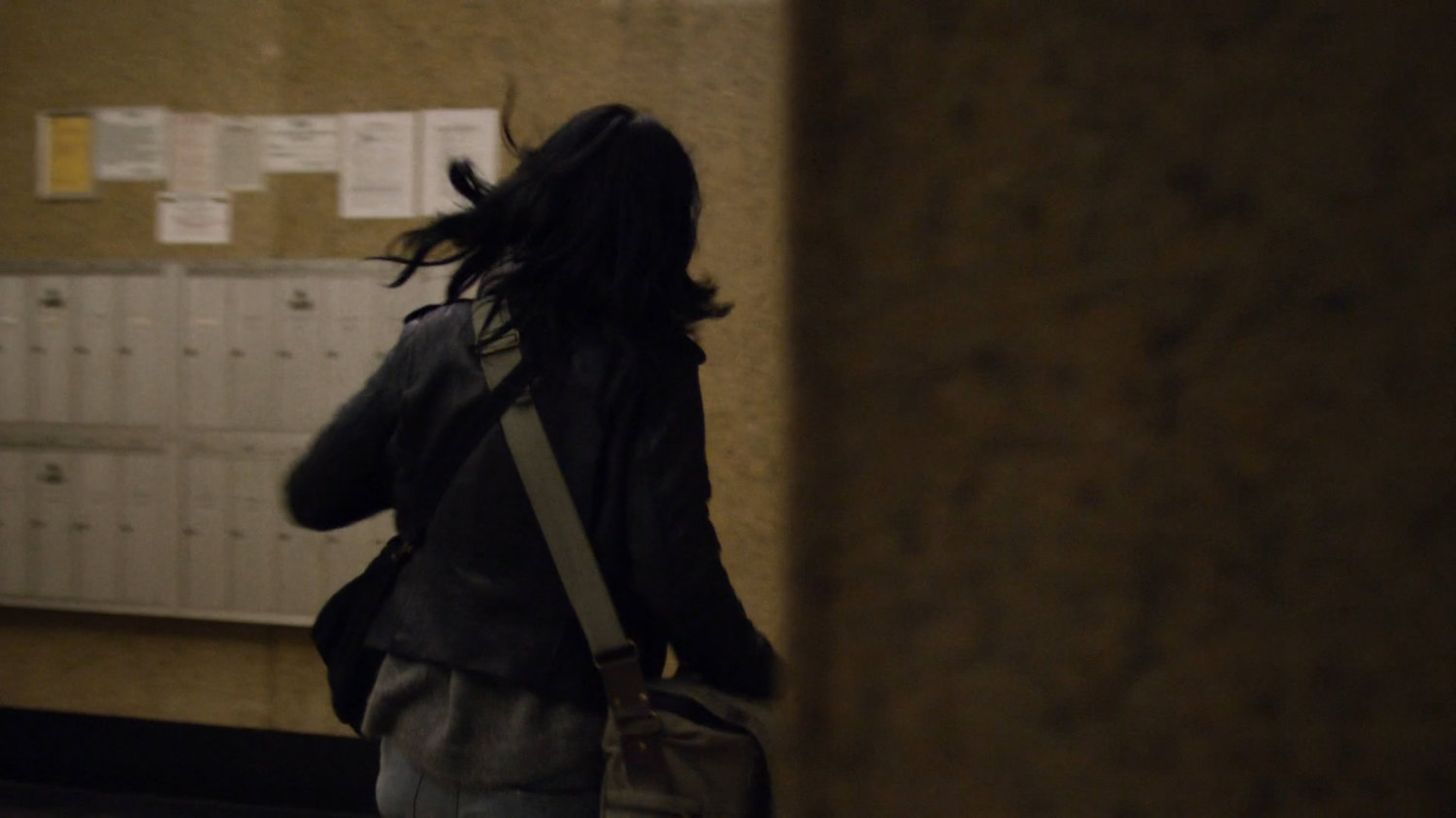 Jessica running through lobby in Alias Investigations building.