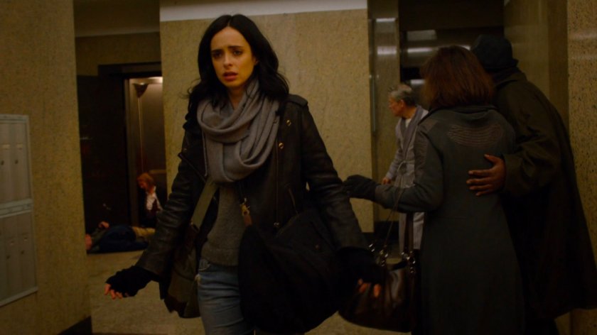 Jessica walking through lobby in Alias Investigations building.