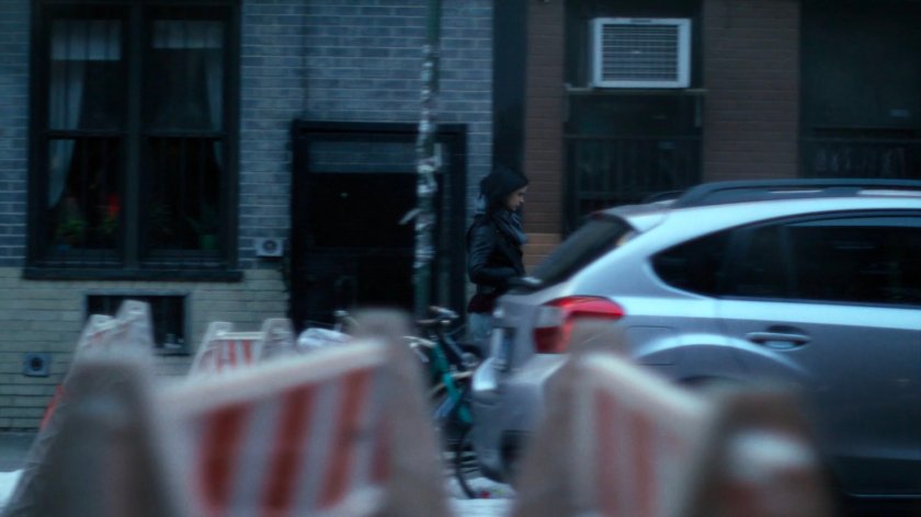 Jessica walking along a sidewalk.