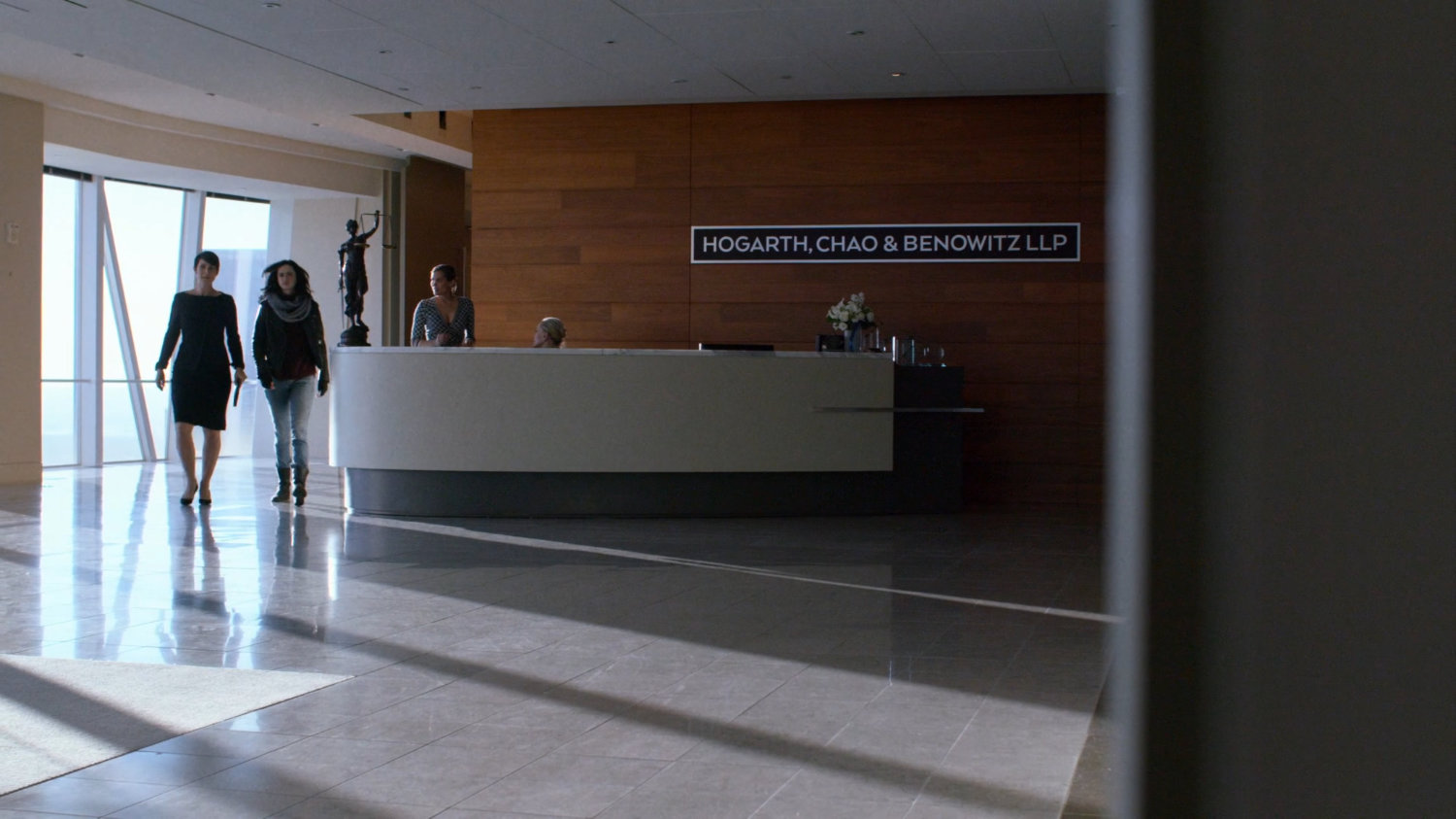 Jeri and Jessica walking in the lobby of Hogarth, Chao, & Benowitz.