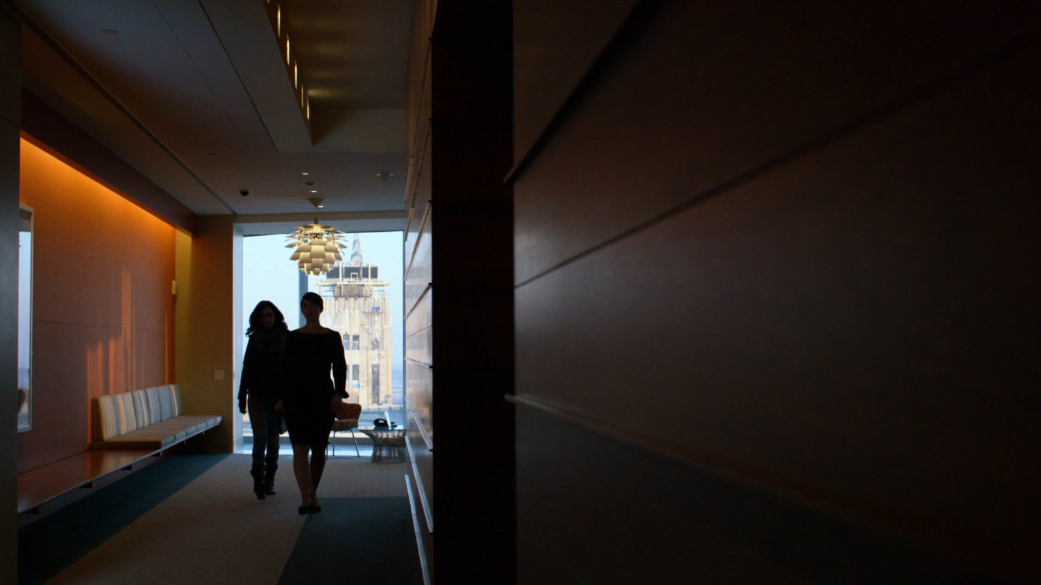 Jeri and Jessica walking through hallway at Hogarth, Chao, & Benowitz.