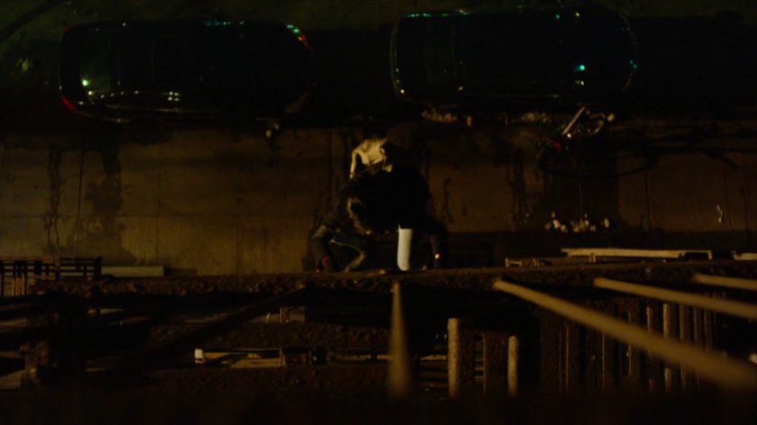 Jessica climbing fire escape across from Luke's bar.