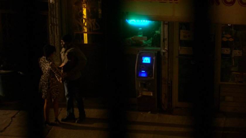 Luke and Gina next door to his bar, in front of entrance to his apartment.