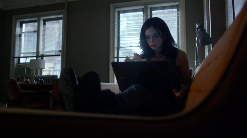 Jessica sitting on couch in her office.