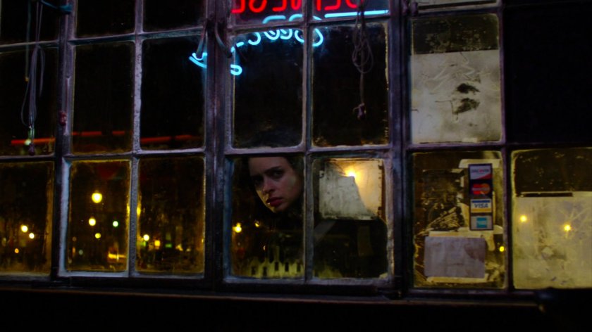 Jessica looking in window outside Luke's bar.