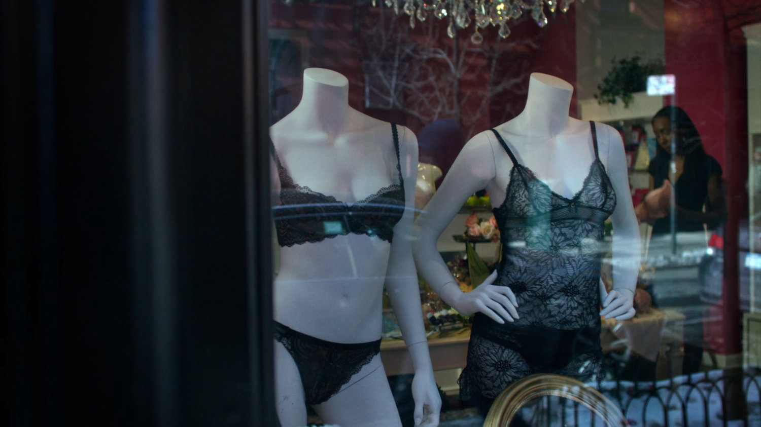 Mannequins in the front window of lingerie shop.