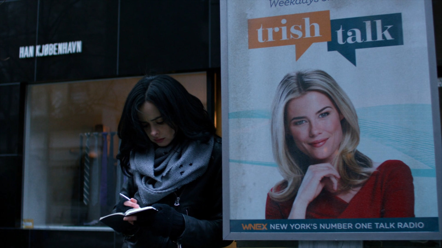 Jessica standing next to advert for TrishTalk.