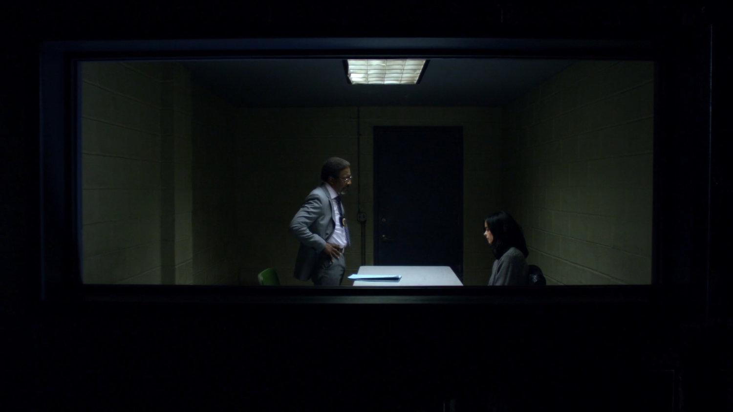 Detective Clemons with Jessica in a police interrogation room.