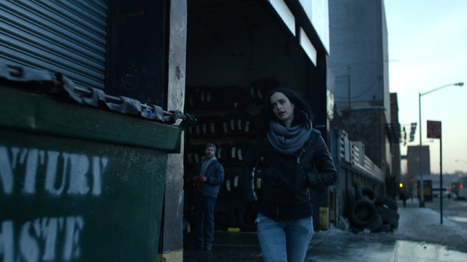 Jessica walking away from auto repair shop.