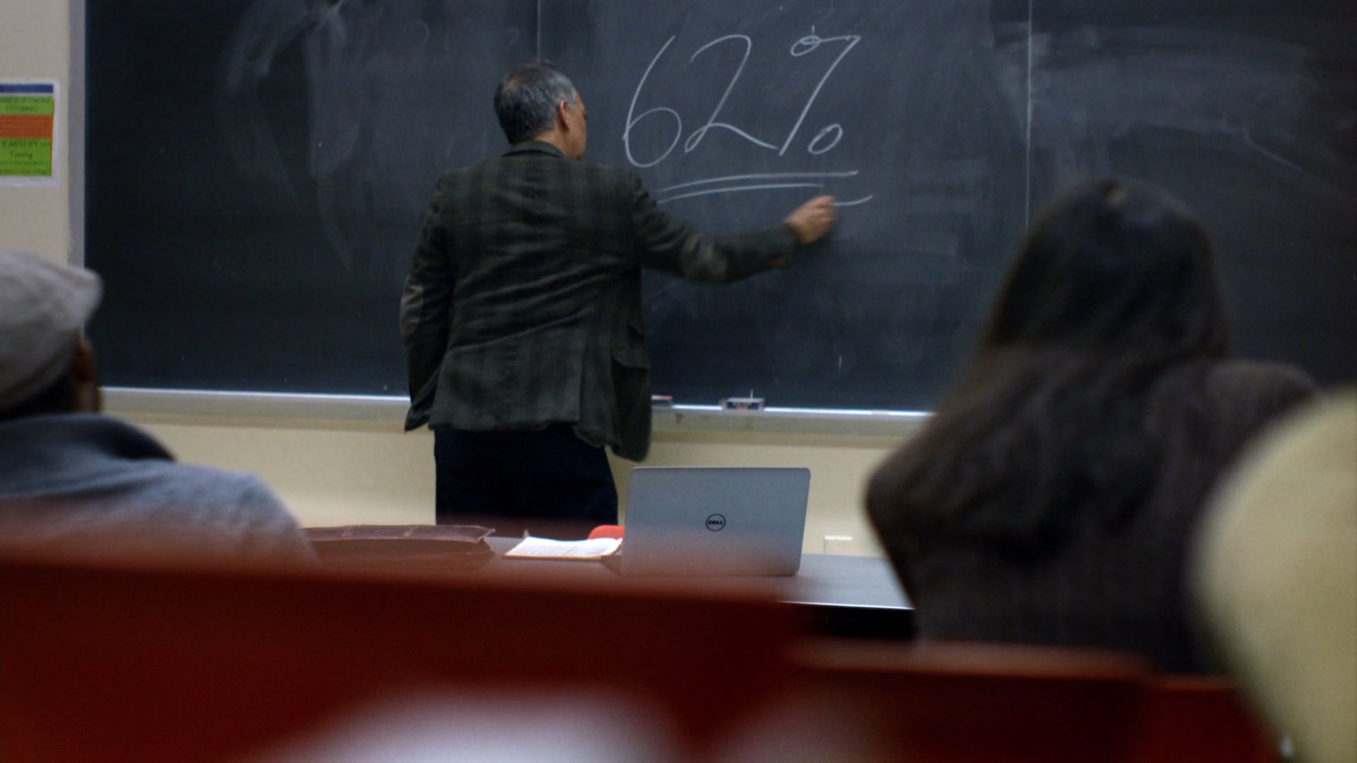 David Kurata at blackboard of his classroom.