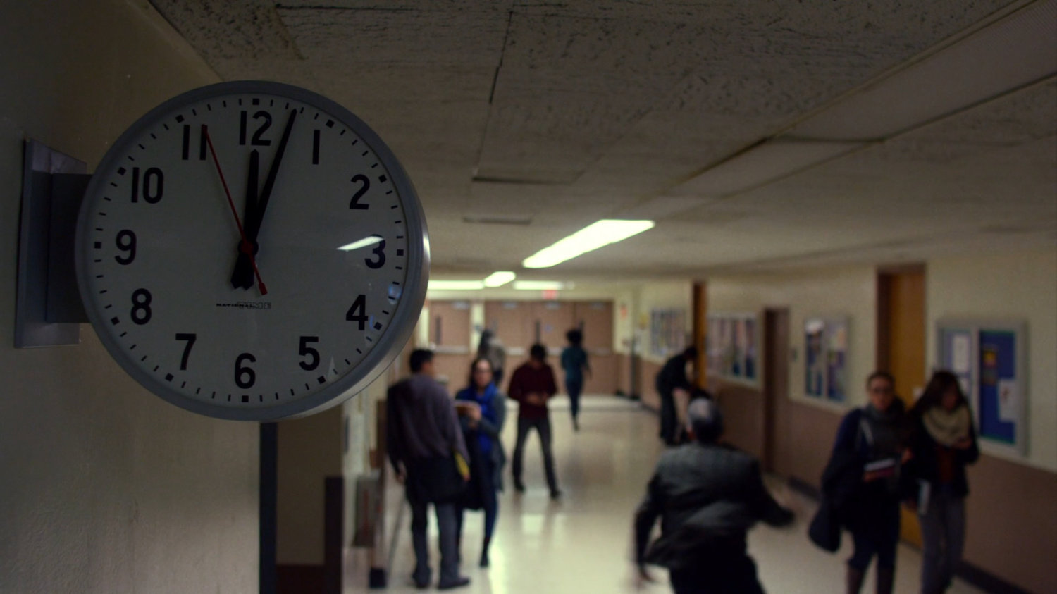 David Kurata running through a school hallway.