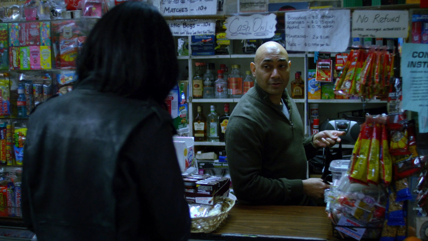 Jessica with cashier in a corner store.