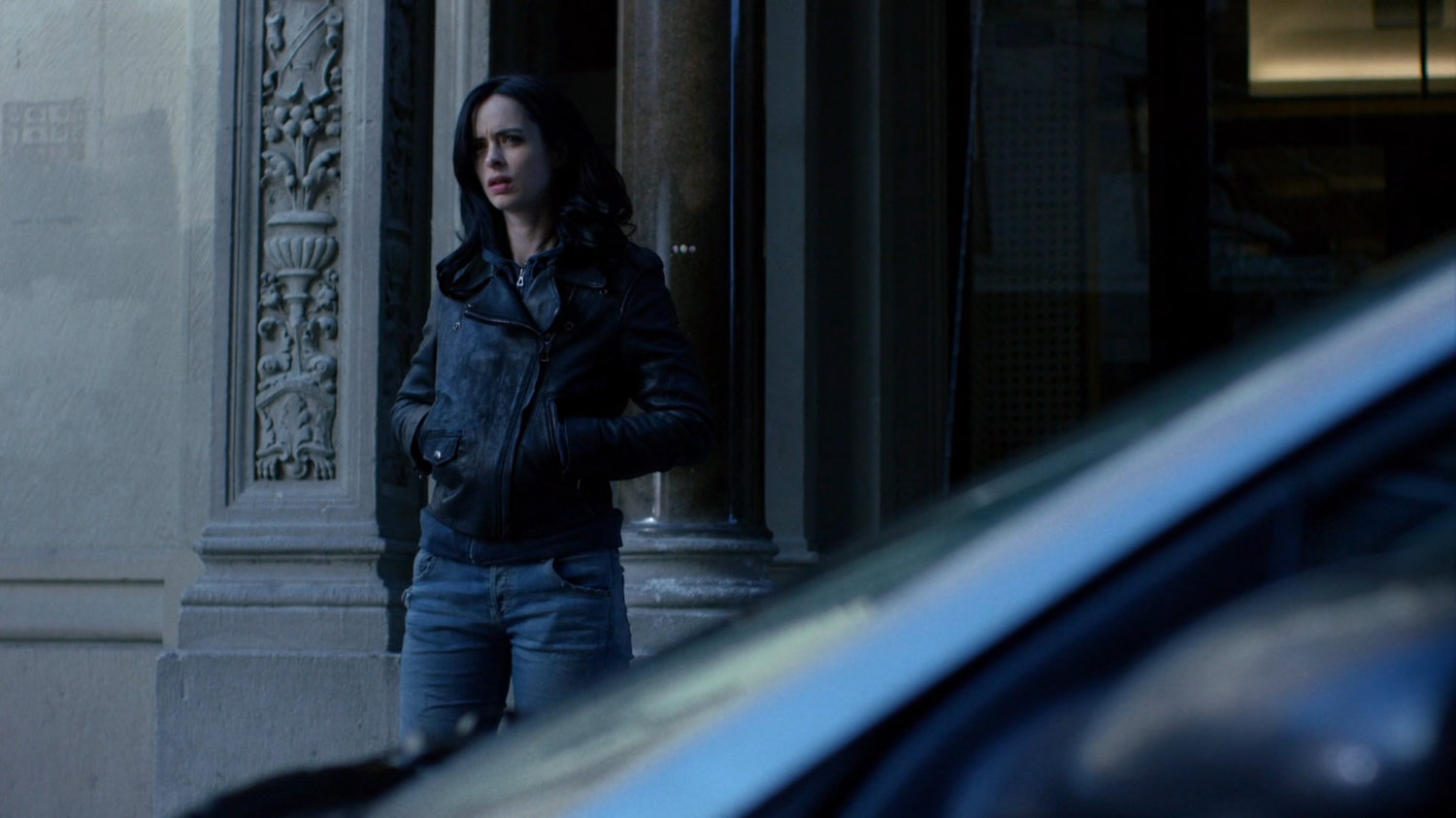 Jessica watching cyclist and Malcolm outside Alias Investigations building.