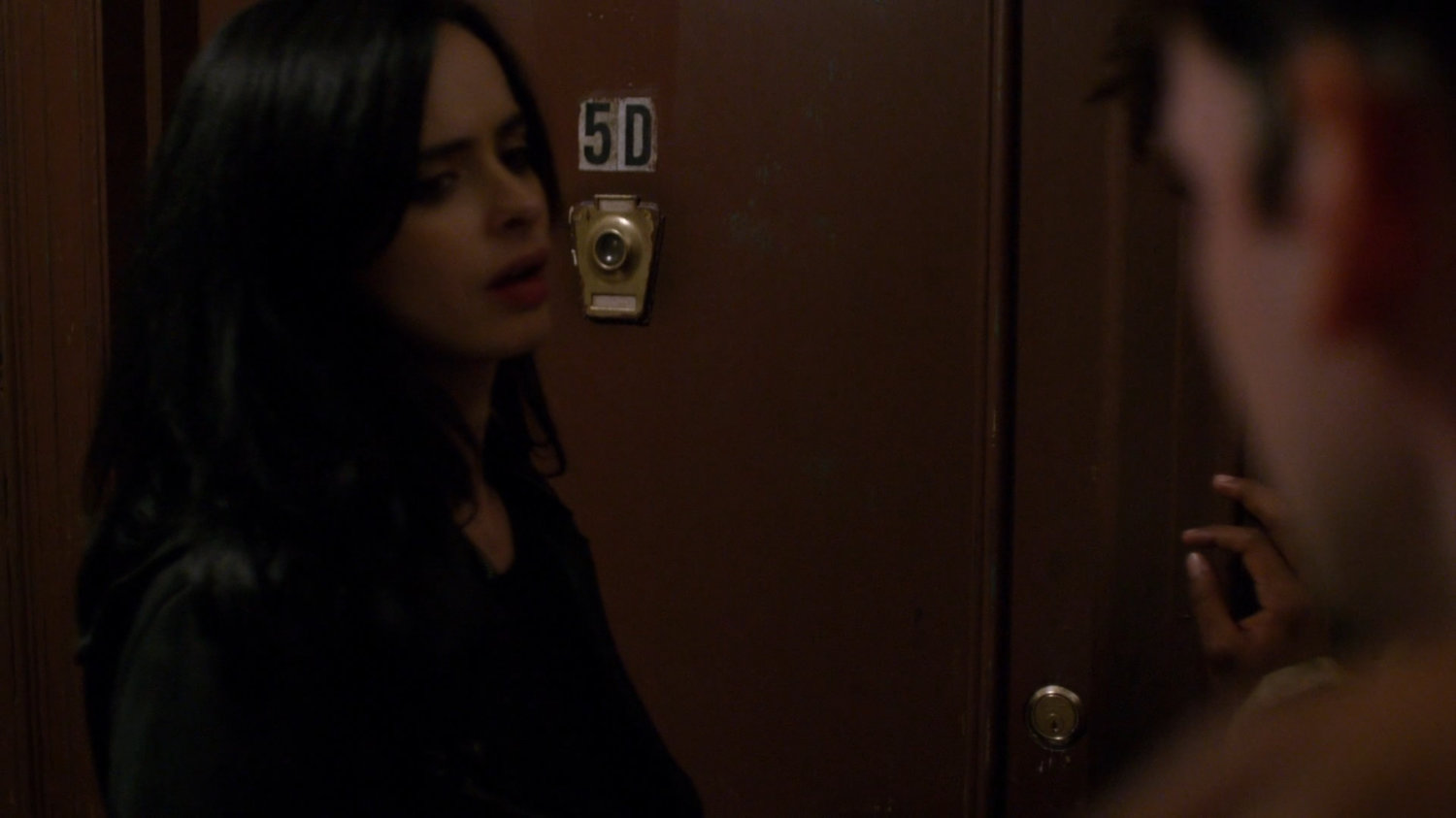 Jessica outside Malcolm's apartment, #5D.