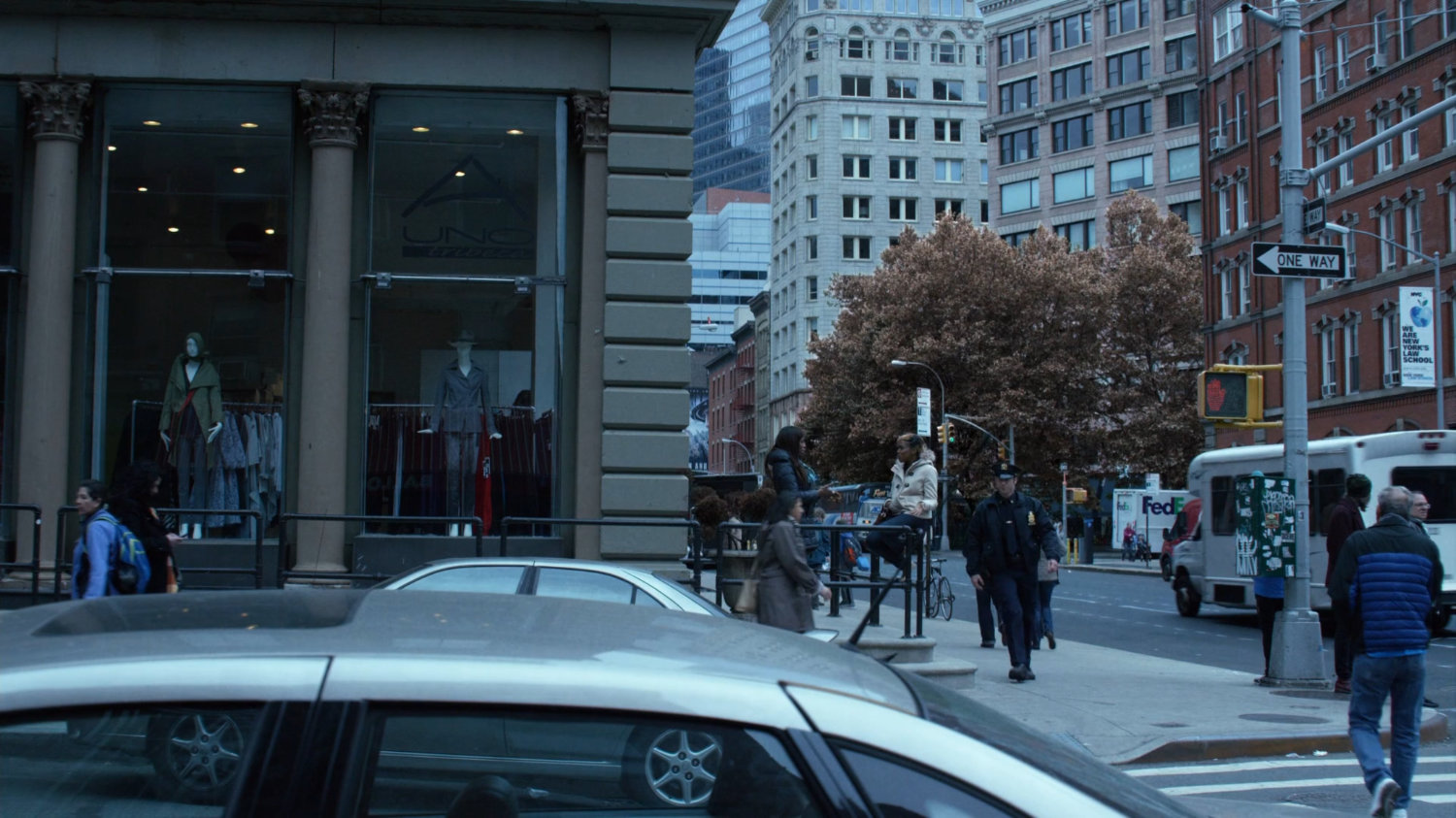 Officer Simpson walking around a corner on a Tribeca sidewalk.