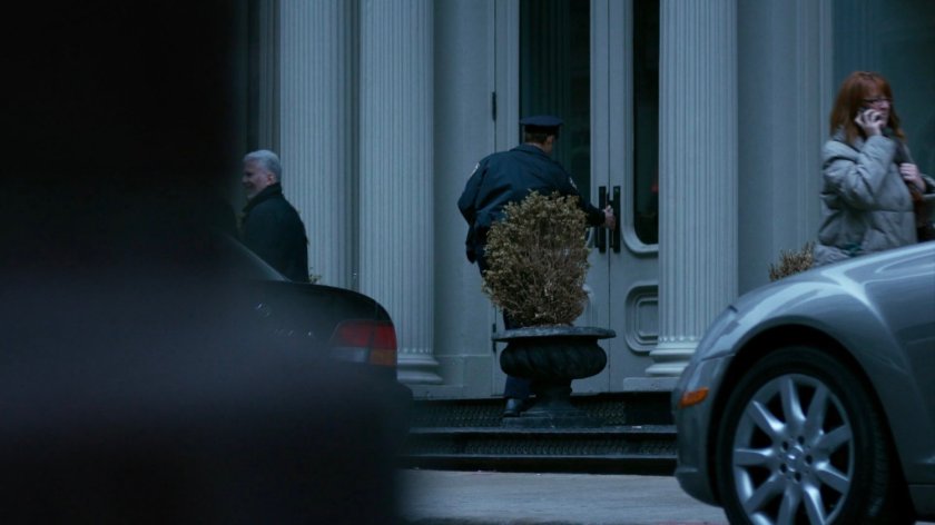 Officer Simpson entering a Tribeca apartment building.