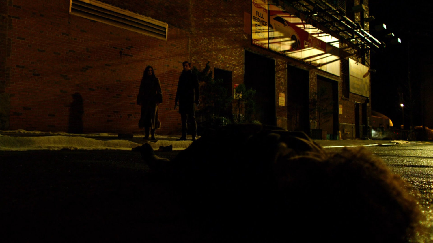 Flashback of Reva laying in street at bus accident sight while Jessica and Kilgrave watch.