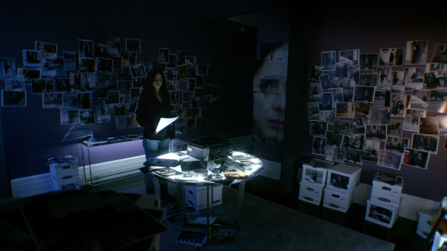 Photos of Jessica cover walls in a room in apartment.
