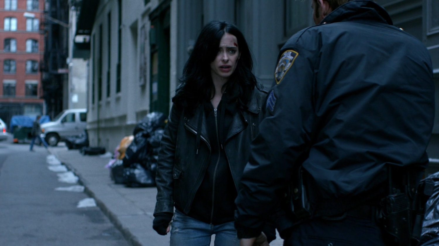 Jessica and Officer Simpson in alley.