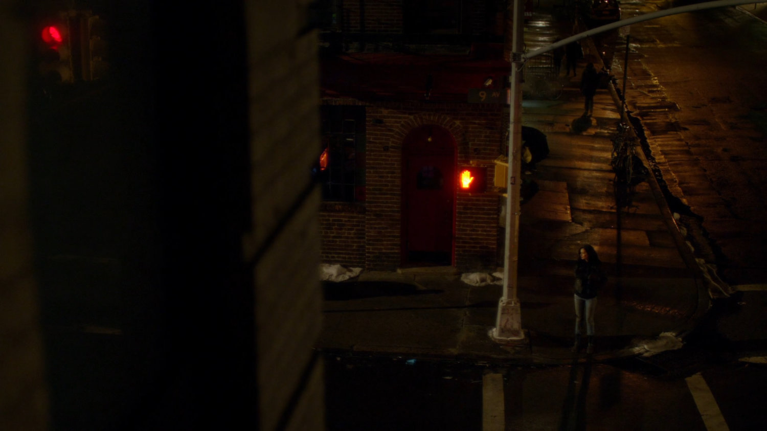 Jessica on corner outside Luke Cage's bar.