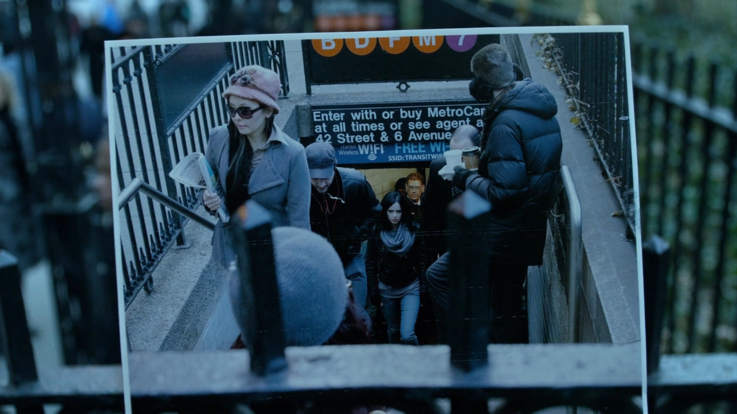 Jessica looking at photo of her exiting the Bryant Park metro station stairway.