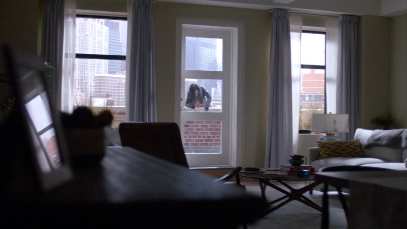 Jessica climbing onto balcony outside Trish's apartment.
