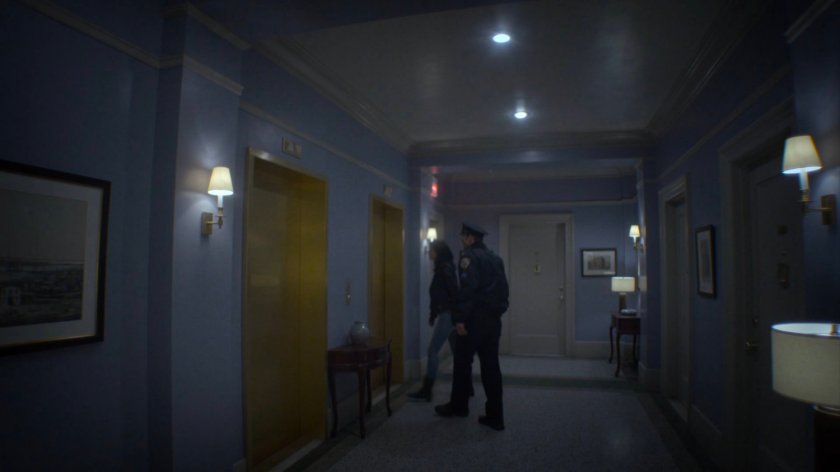 Jessica and Officer Simpson in hallway outside Trish's apartment.