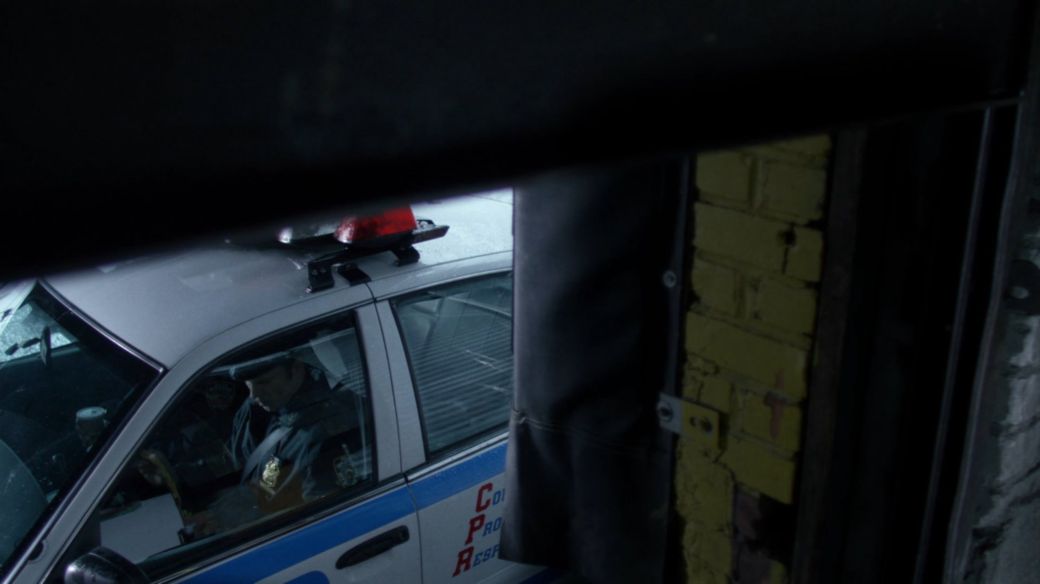 Officer Simpson parked in squad car.