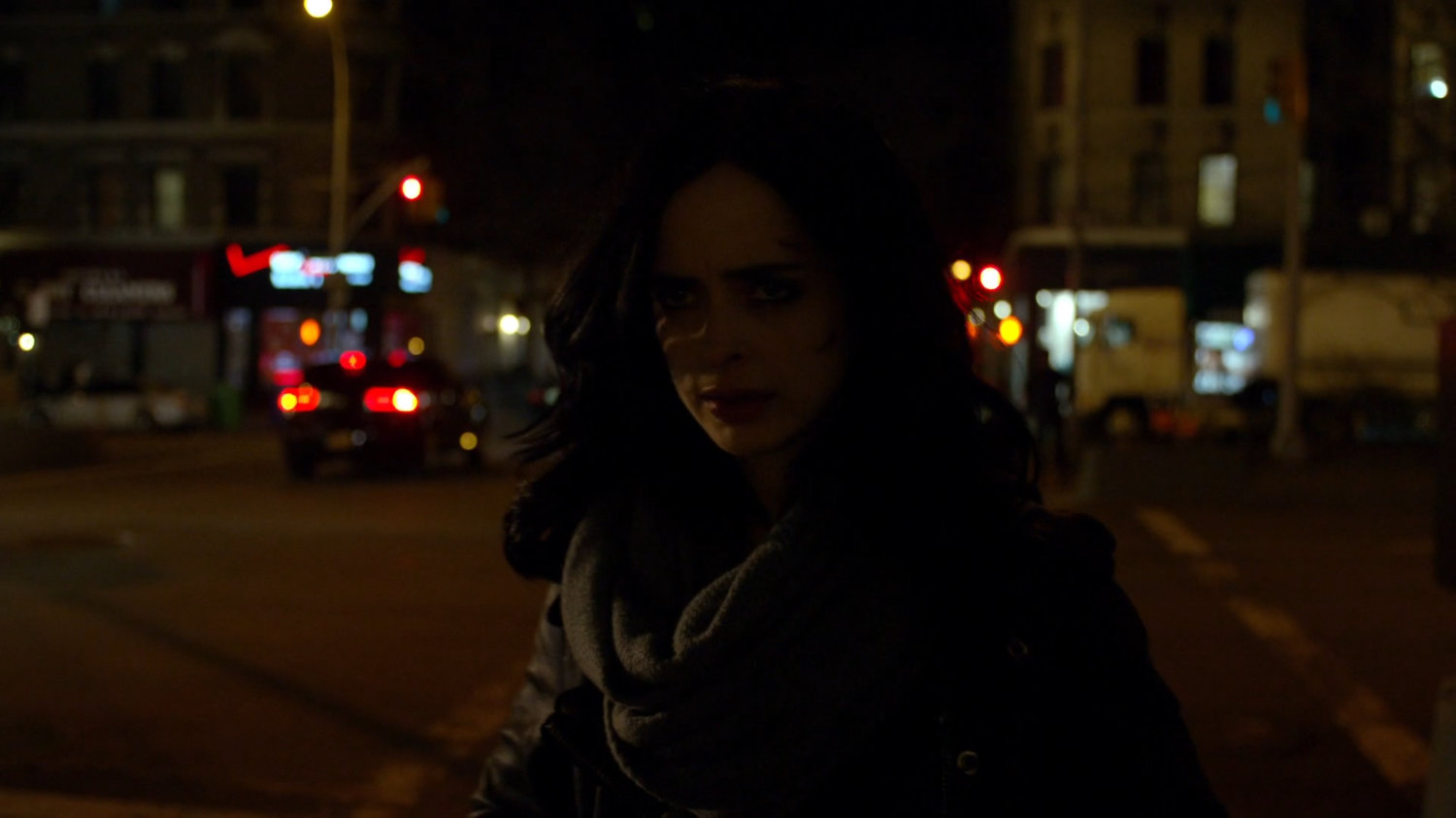 Jessica outside her building at night.