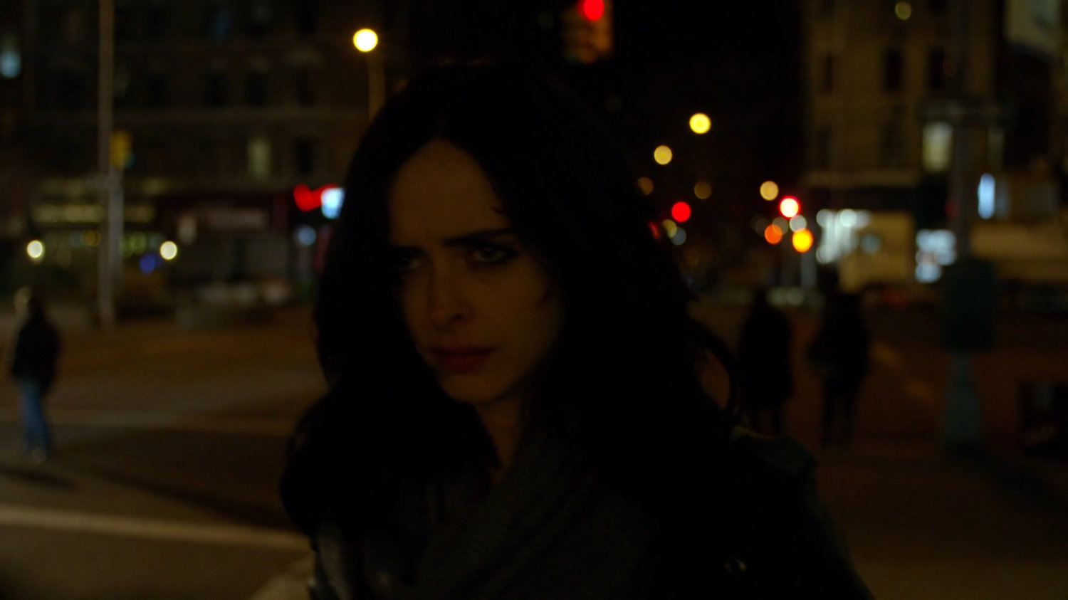 Jessica outside her building at night.