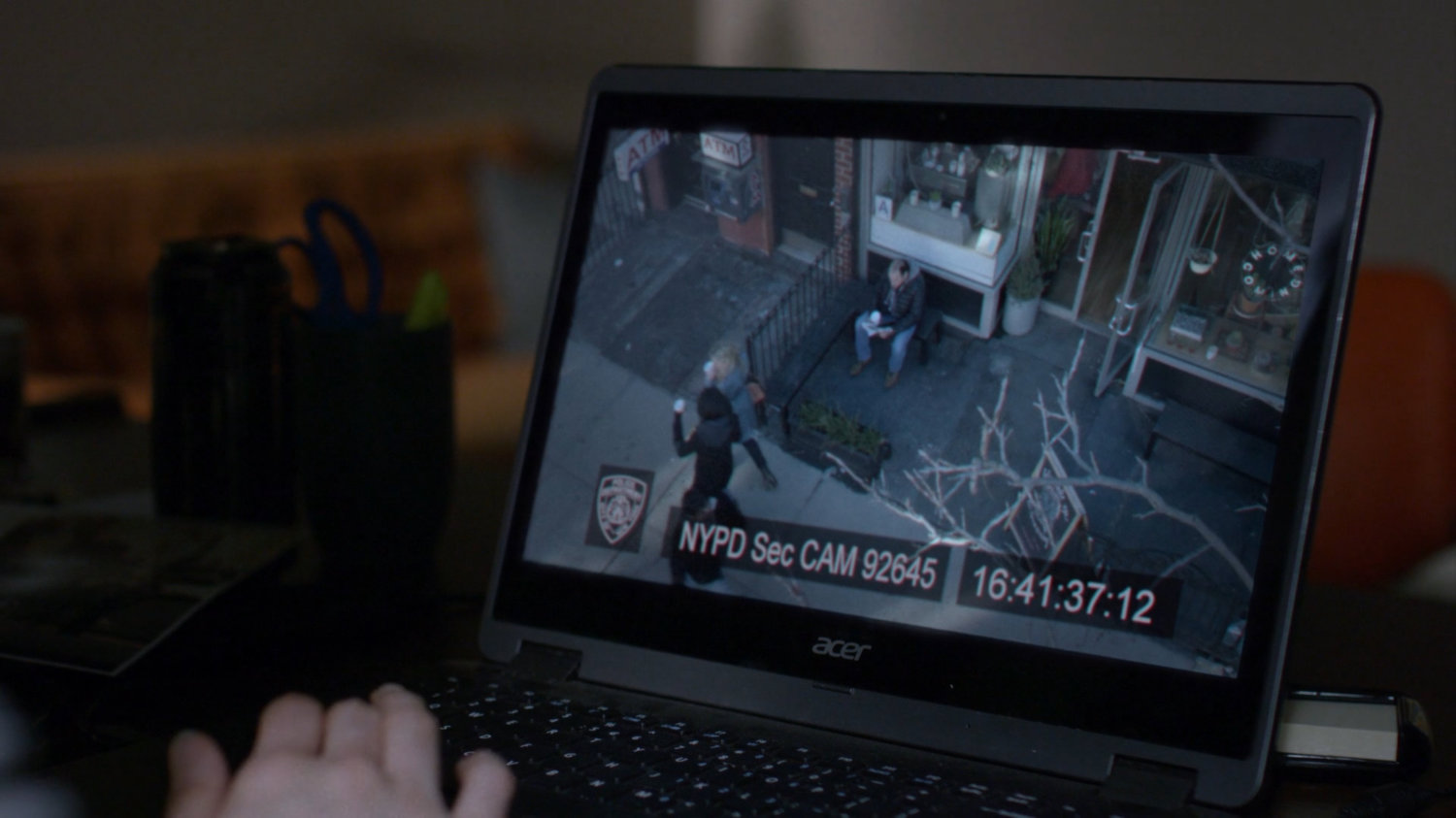 Jessica watching surveillance footage of her and Trish.