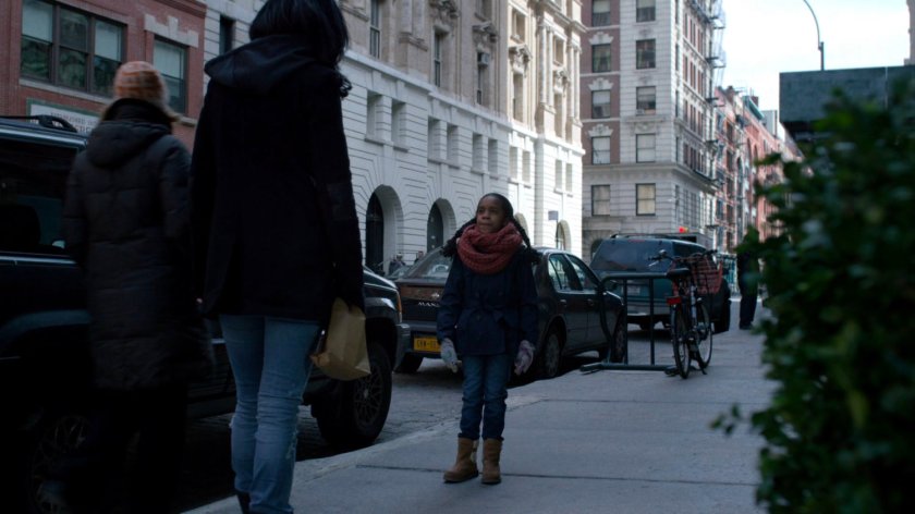 Jessica talking to young girl on the sidewalk.