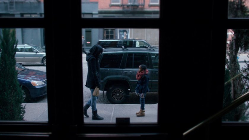 Jessica talking to young girl on the sidewalk.