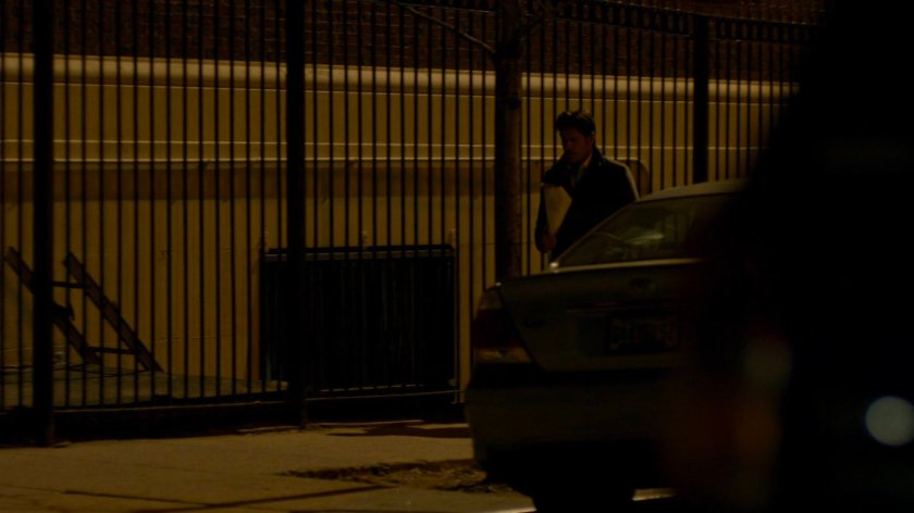 Carlo Eastman walking along sidewalk at nighttime.