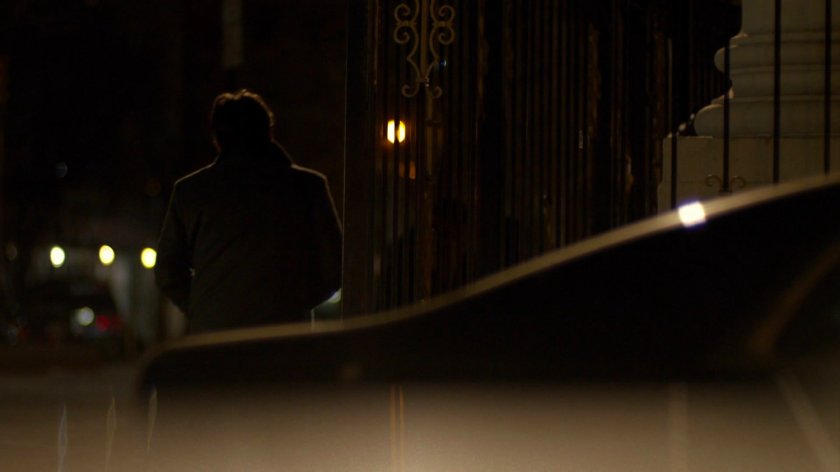 Carlo Eastman walking along sidewalk at nighttime.