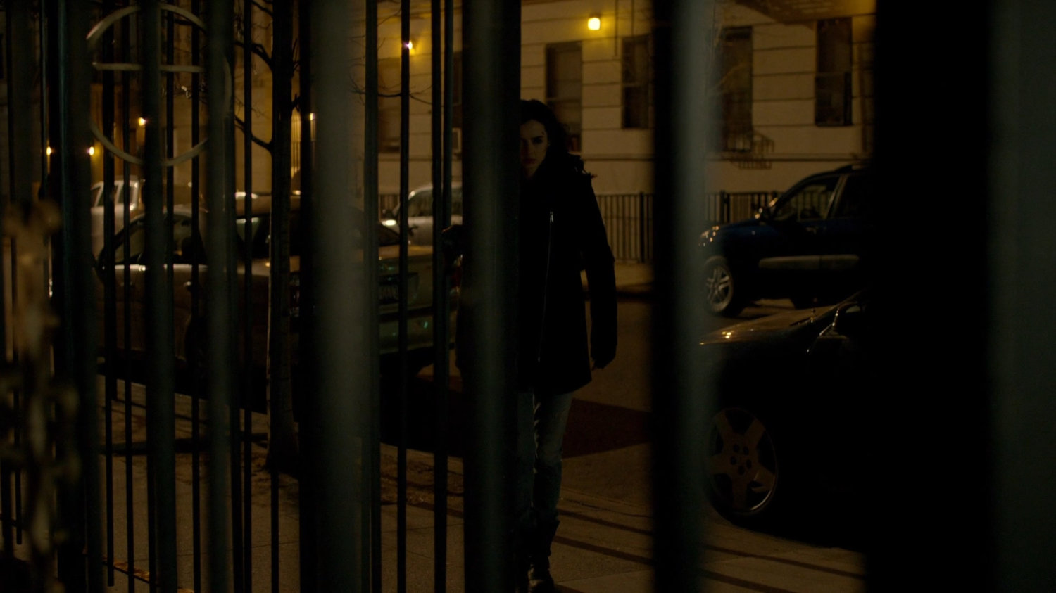 Jessica following Carlo Eastman along sidewalk at nighttime.