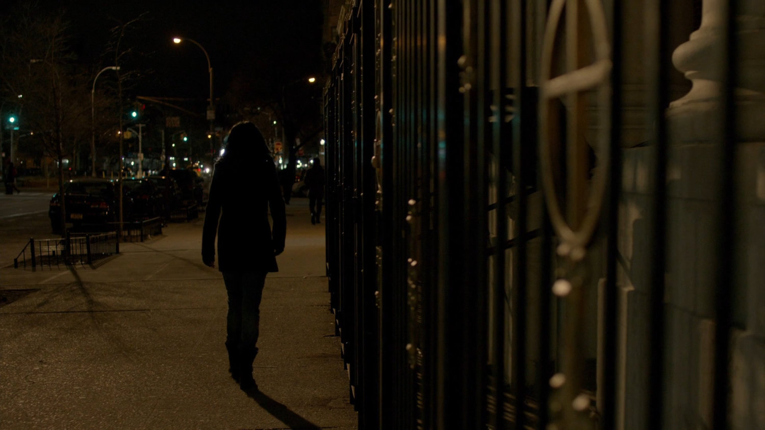 Jessica following Carlo Eastman along sidewalk at nighttime.