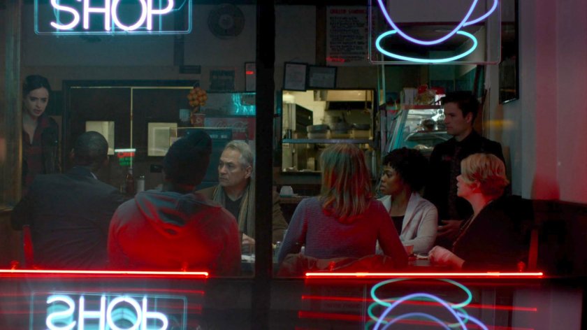 A support meeting of Kilgrave victims inside a diner.