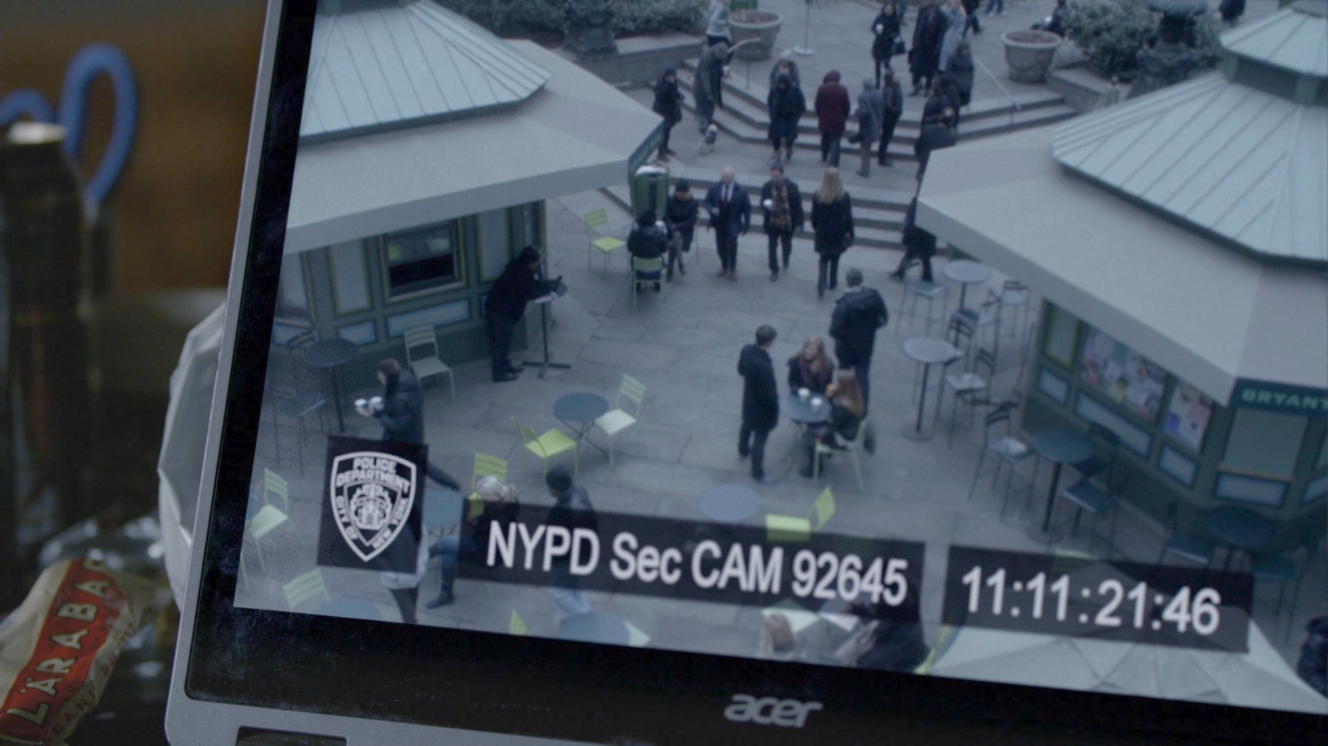 Jessica watching security footage of herself in Bryant Park.