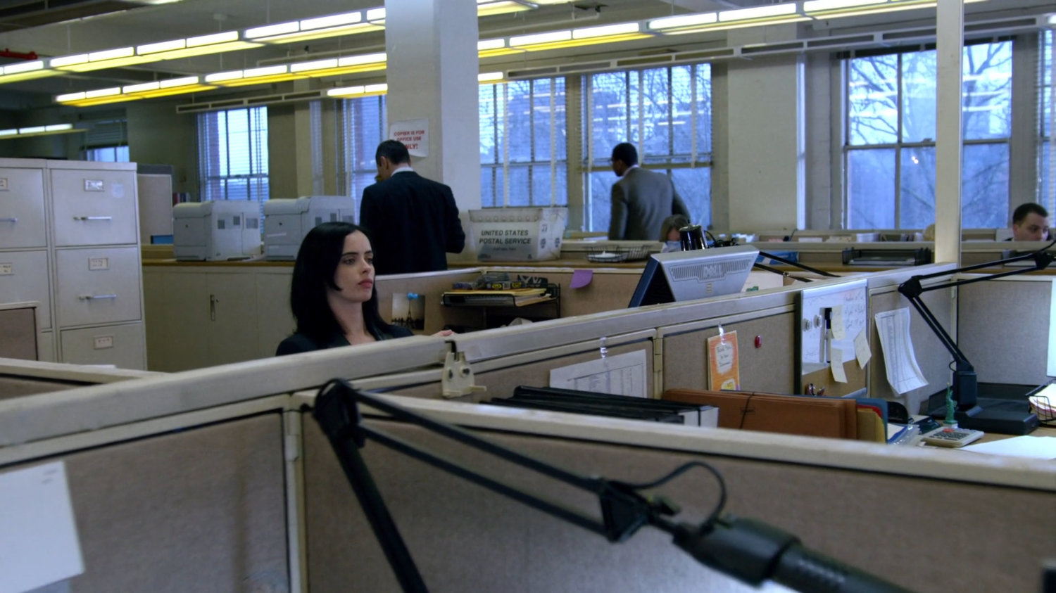 Jessica at her desk in office building.
