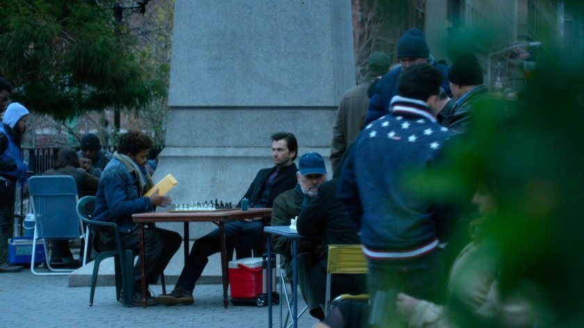 Malcolm at table with Kilgrave in Union Square Park.