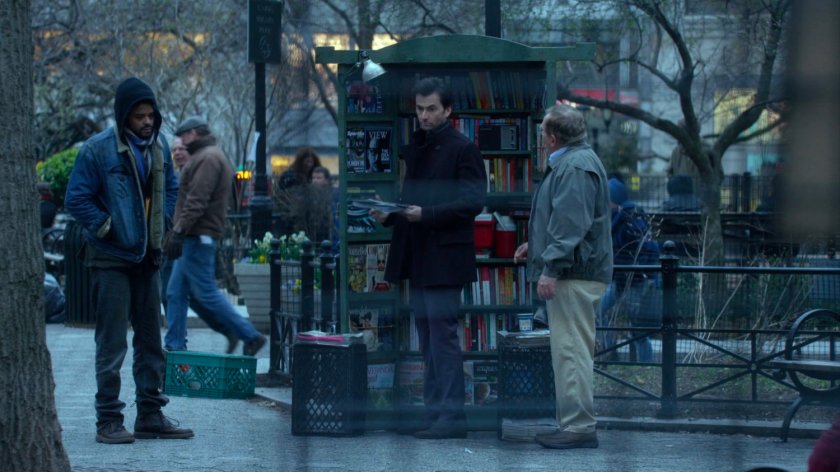Malcolm at magazine rack with Kilgrave in Union Square Park.