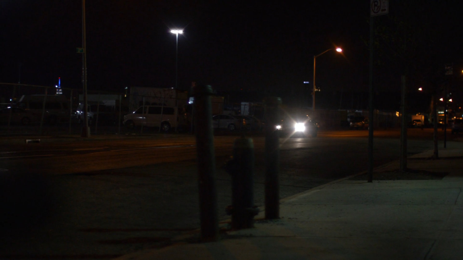 Car driving along a dark street outside a decommissioned CDC facility.