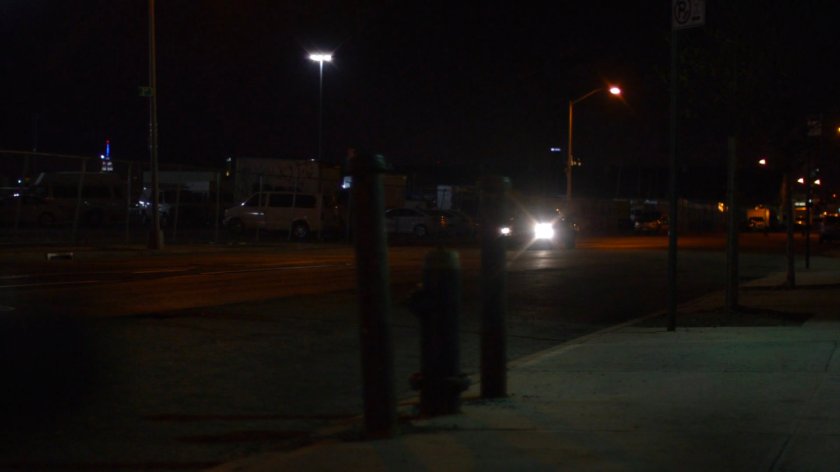Car driving along a dark street outside a decommissioned CDC facility.