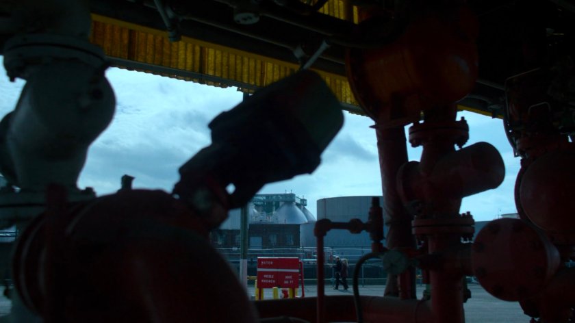 Will and Trish walking outside an industrial plant.